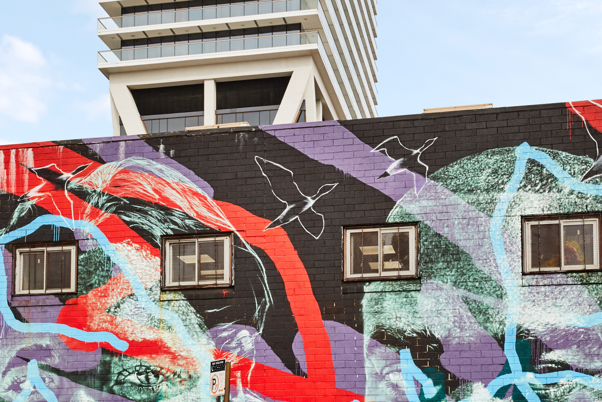 Colorful mural with modern building backdrop