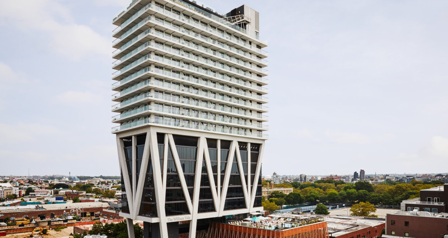 Modern high-rise hotel with cantilevered design over Brooklyn.