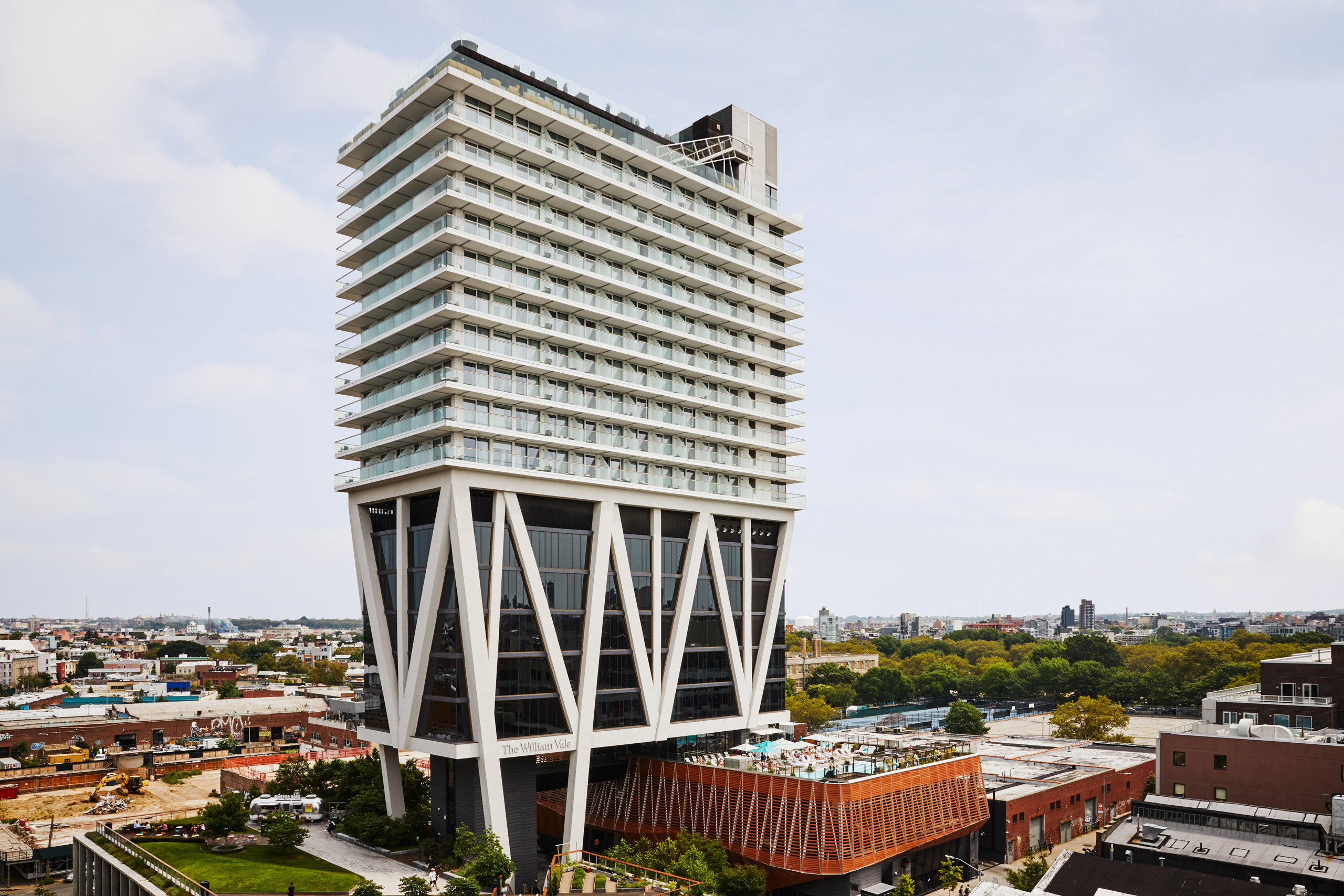 Modern high-rise hotel with cantilevered design over Brooklyn.
