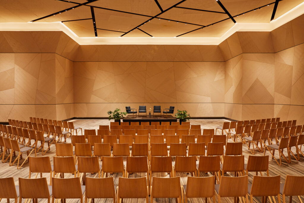 Modern ballroom set for a panel discussion.