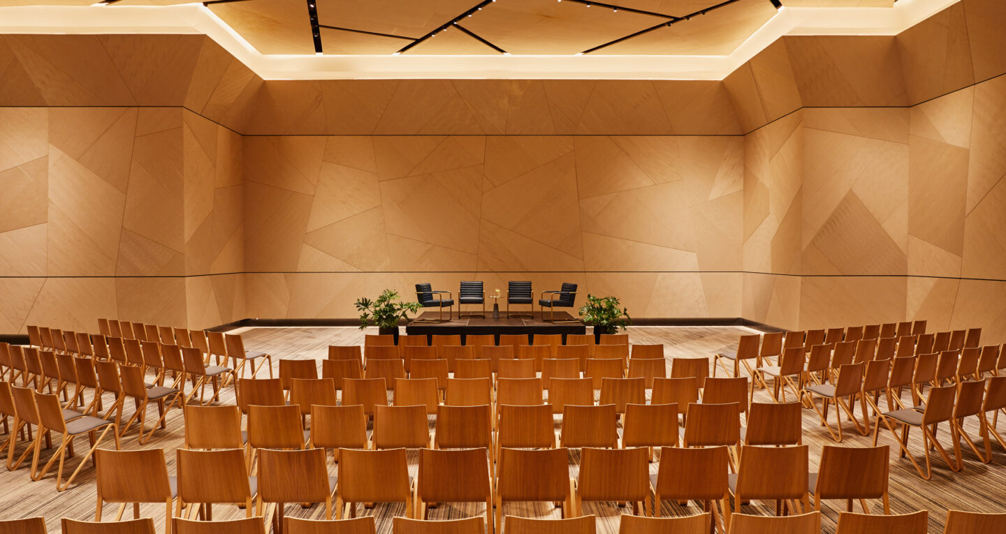Modern ballroom set for a panel discussion.