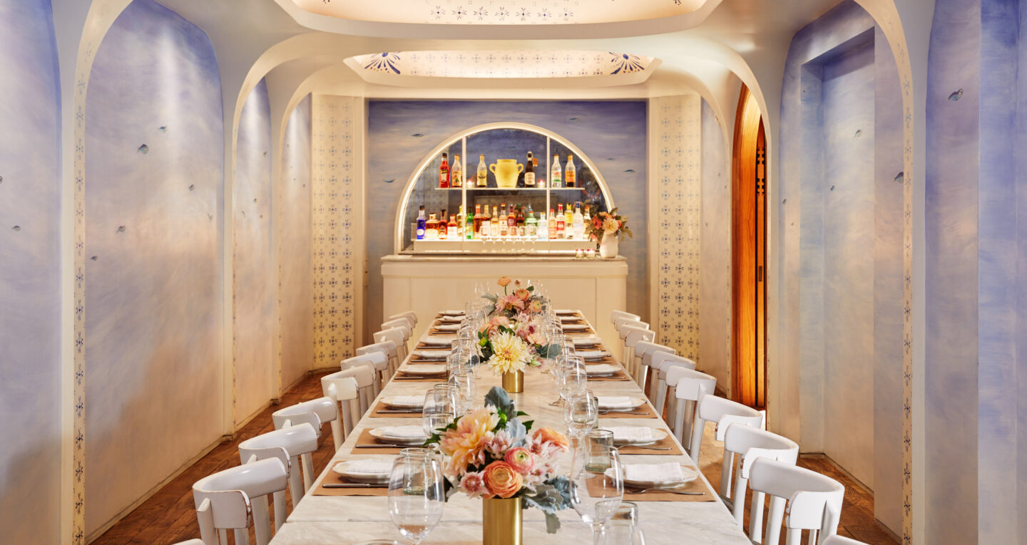 Elegant private dining room with marble table and bar.