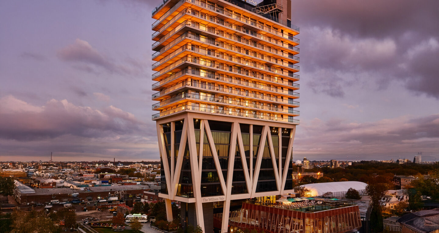 The William Vale hotel illuminated at sunset in Brooklyn.