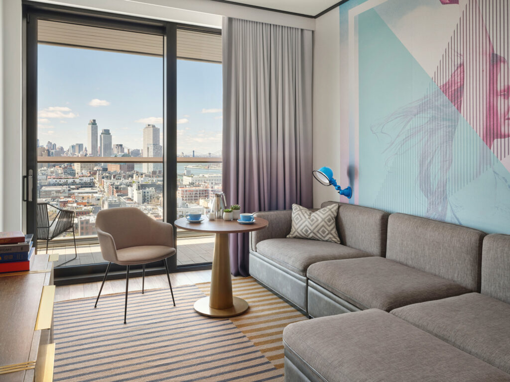 Modern sitting area with couch and skyline view.