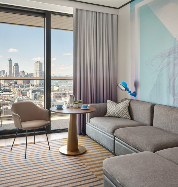 Modern sitting area with couch and skyline view.
