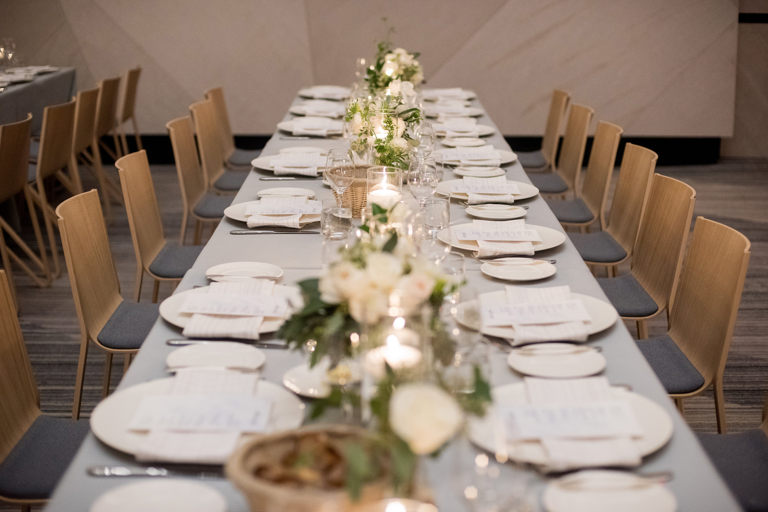 Long banquet table with formal place settings.