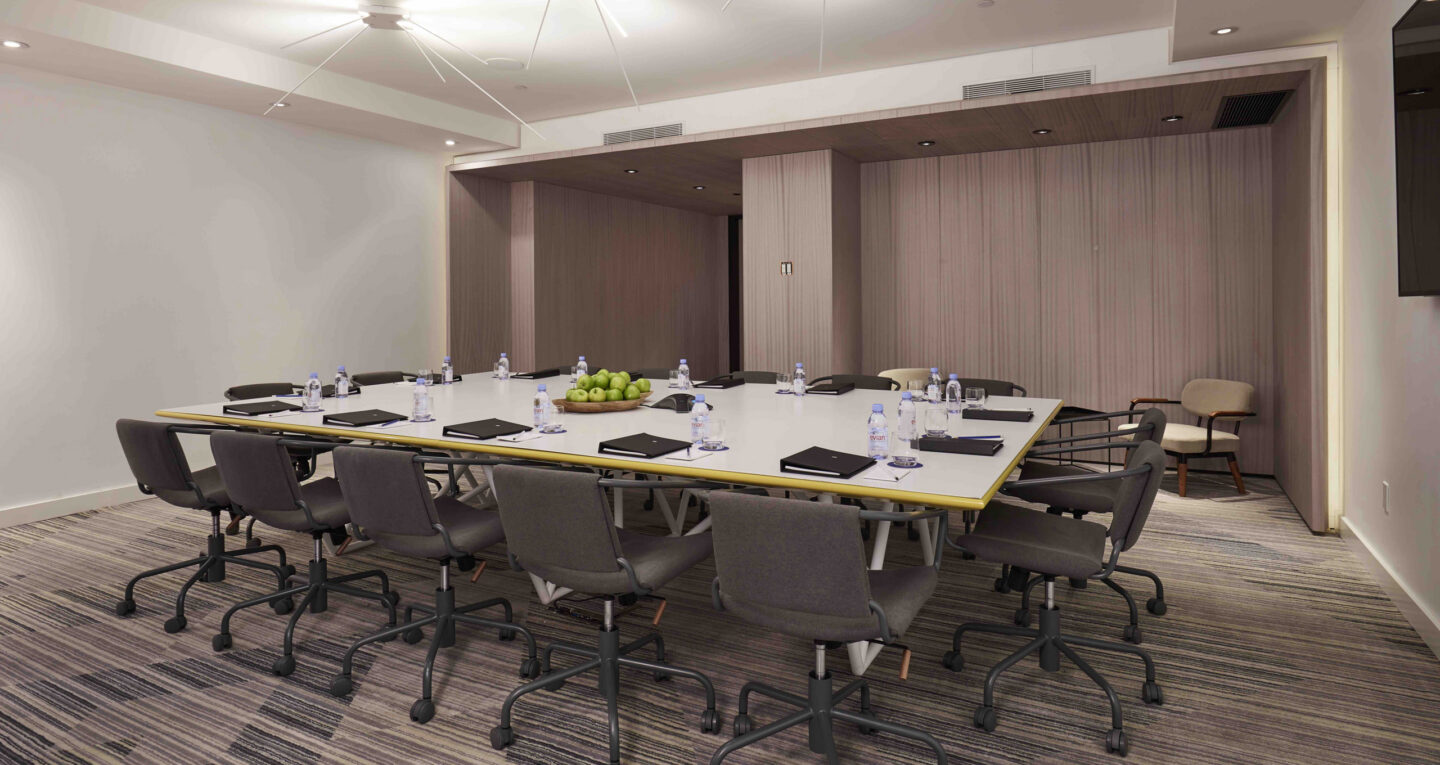 Contemporary boardroom with rolling chairs and square table set for a meeting.