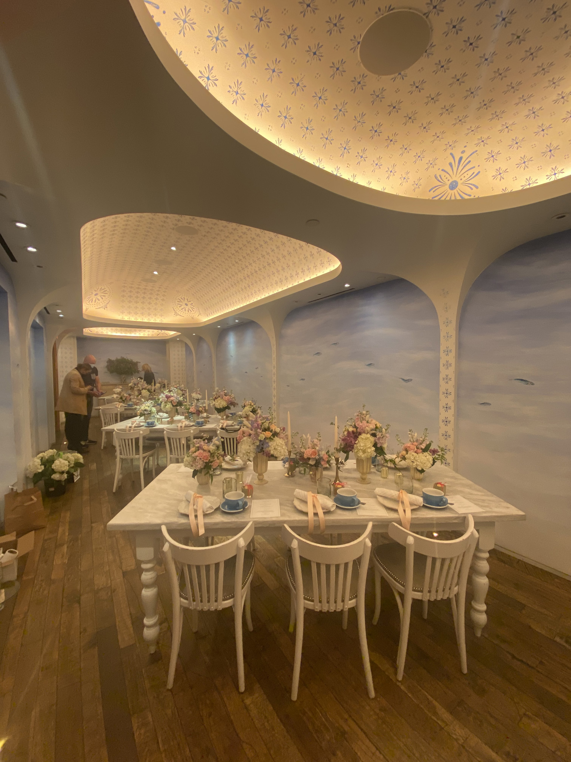 Table settings with floral centerpieces in private dining room.