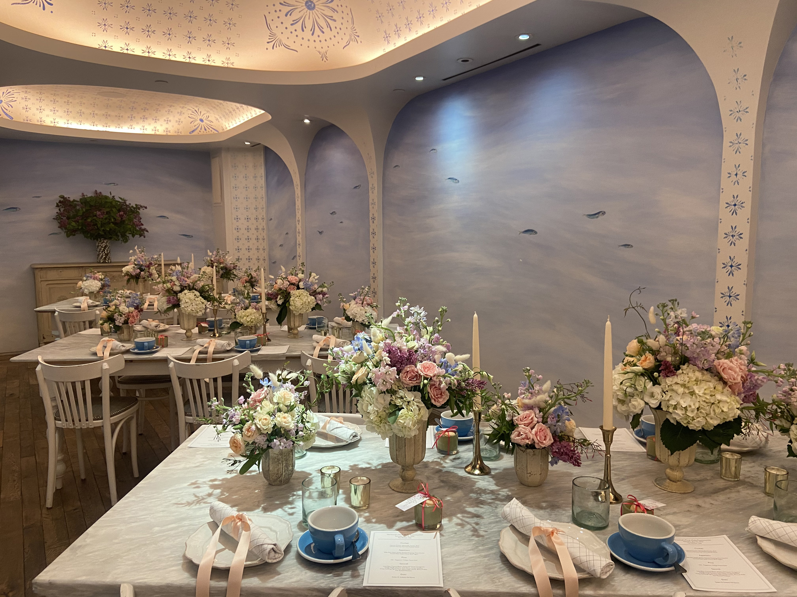 Private dining room set for floral-themed event.