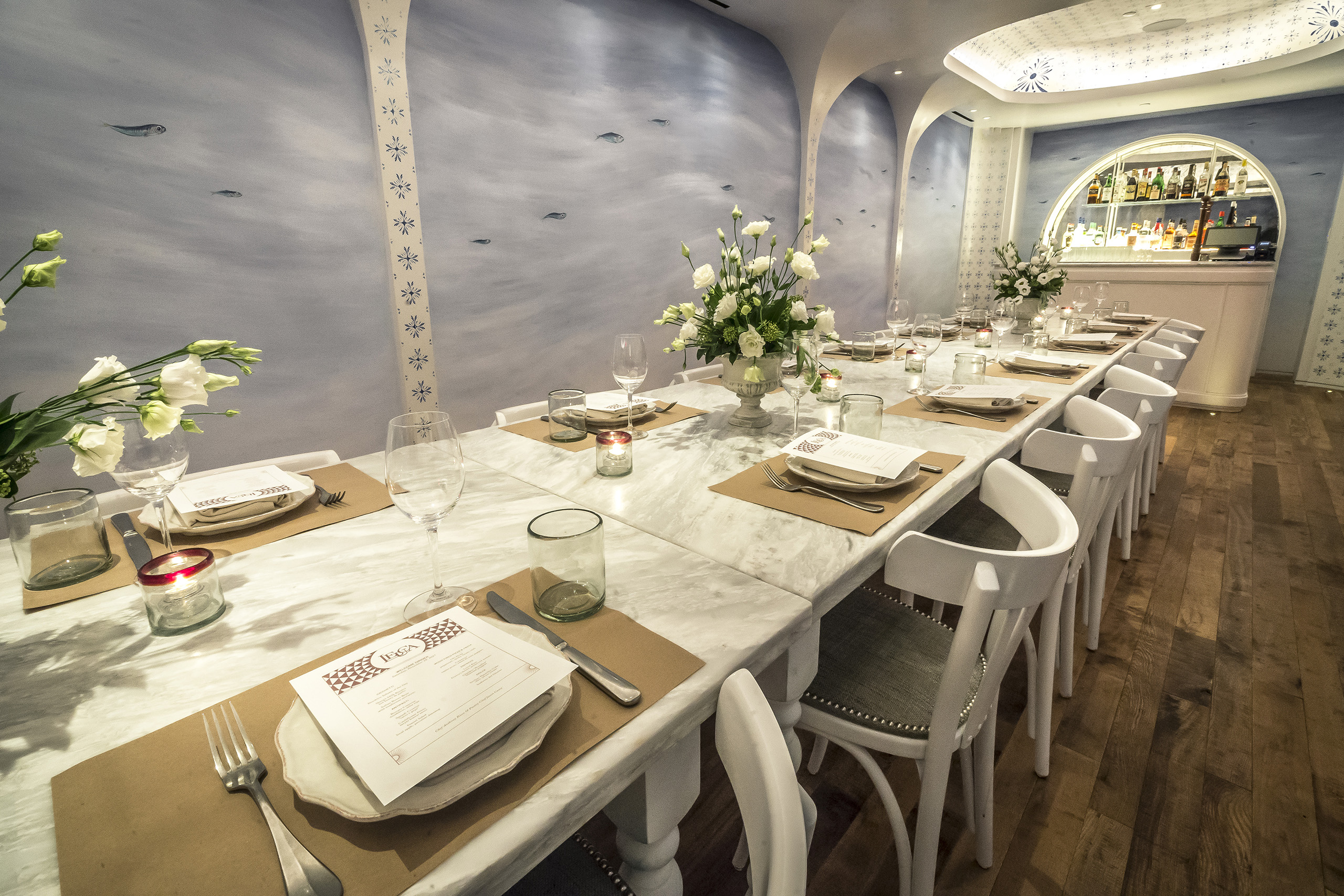 Marble table private dining room with menu place settings.