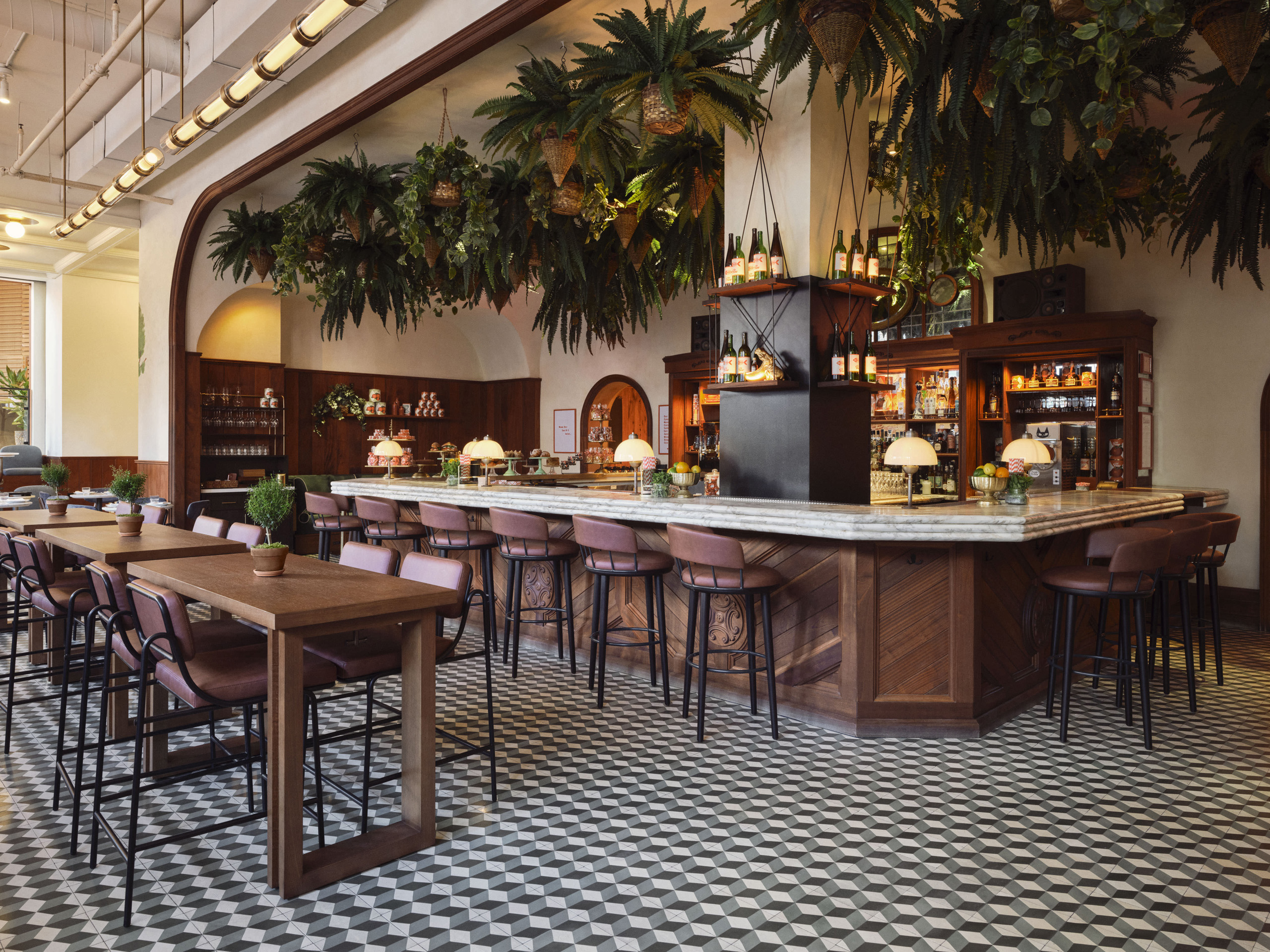 Stylish bar with hanging plants and tiled floor