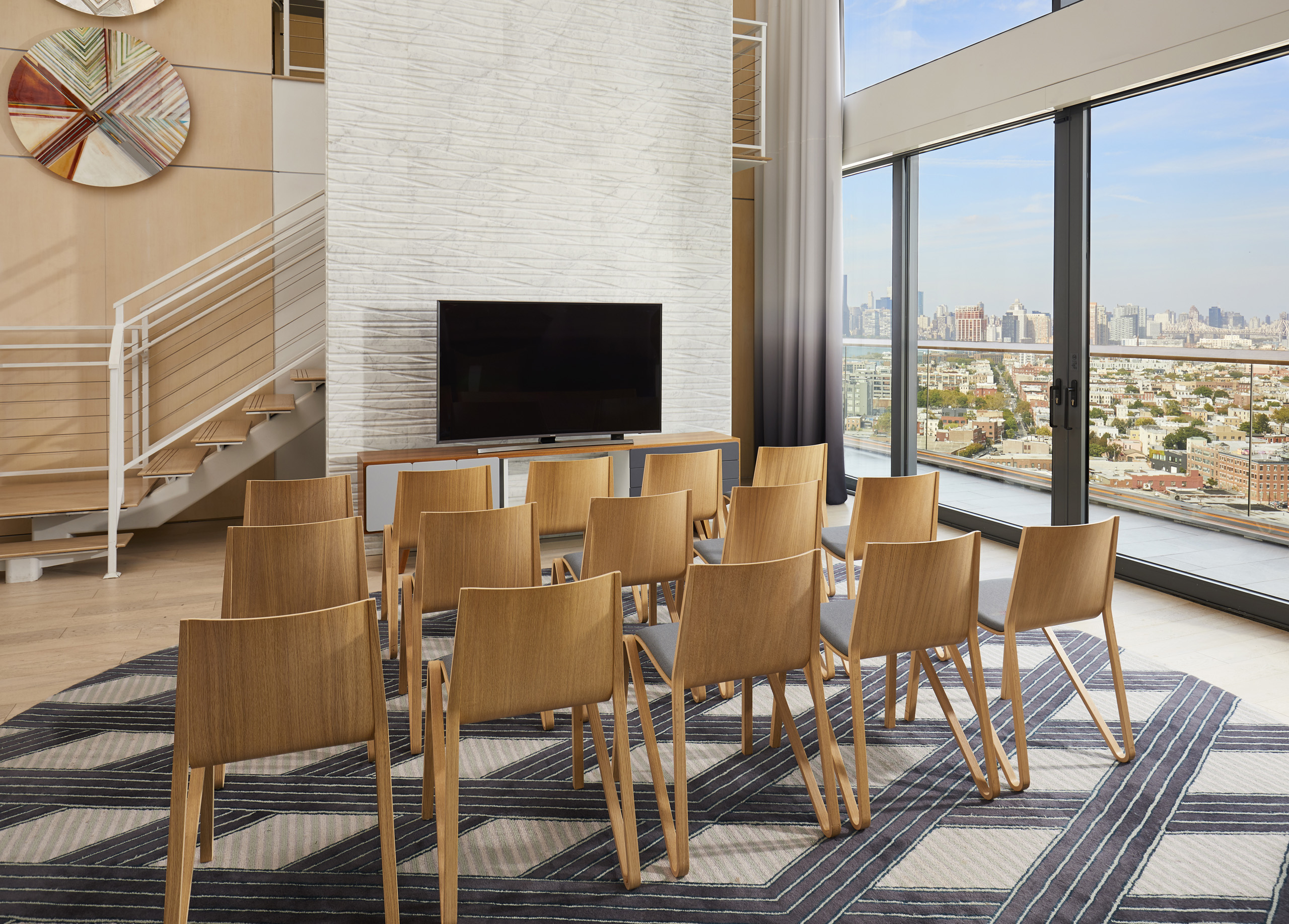 Theater-style seating facing screen in modern meeting room.