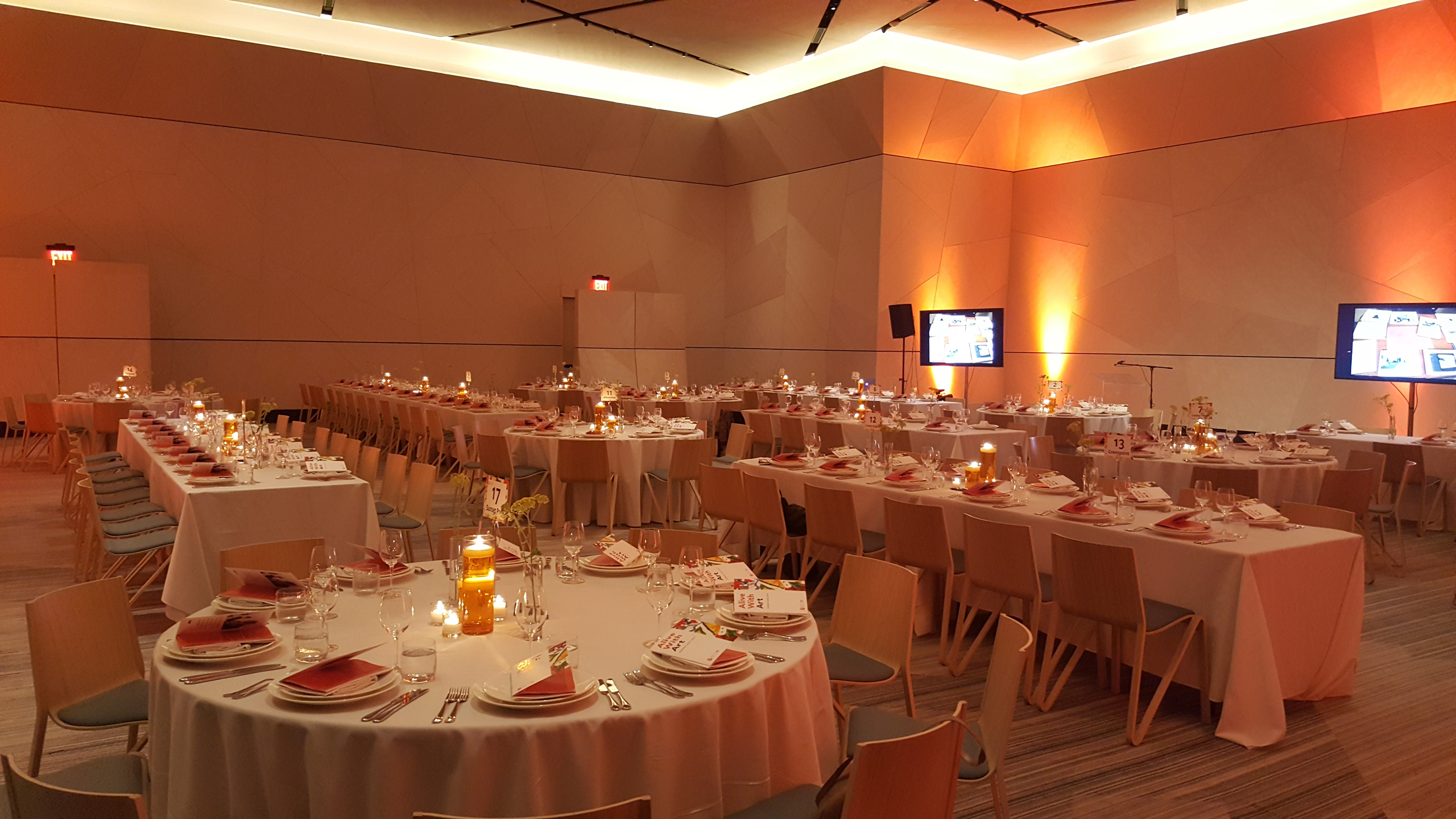 Elegant banquet setup in a modern ballroom with warm ambient lighting.