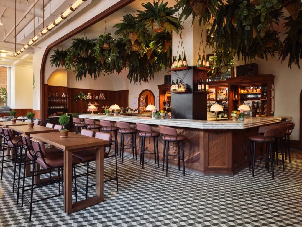 Elegant bar with hanging greenery and marble countertop.