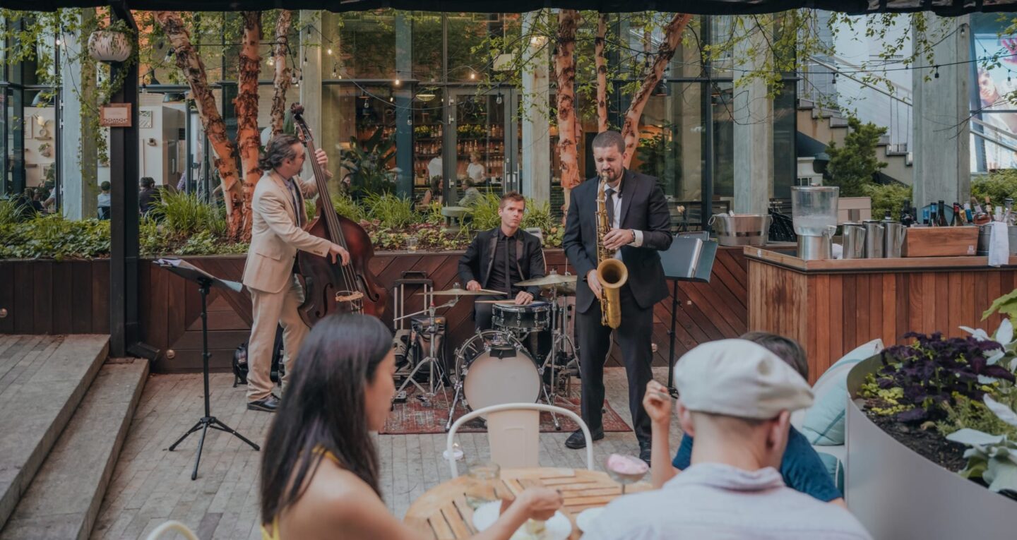 Live jazz band performing on an outdoor restaurant patio.