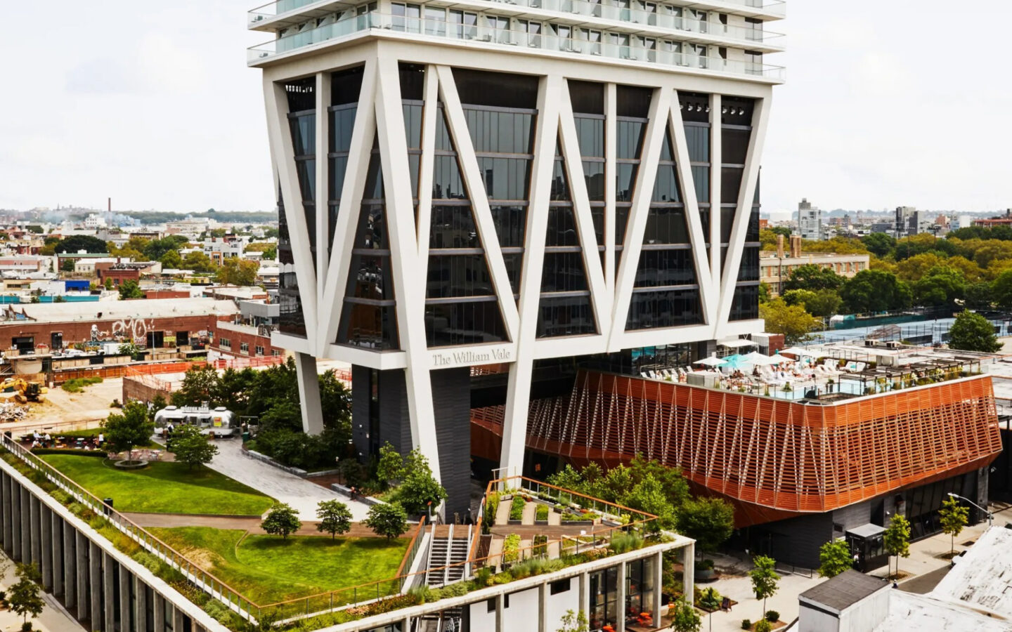 Exterior view of tall modern hotel in cityscape setting