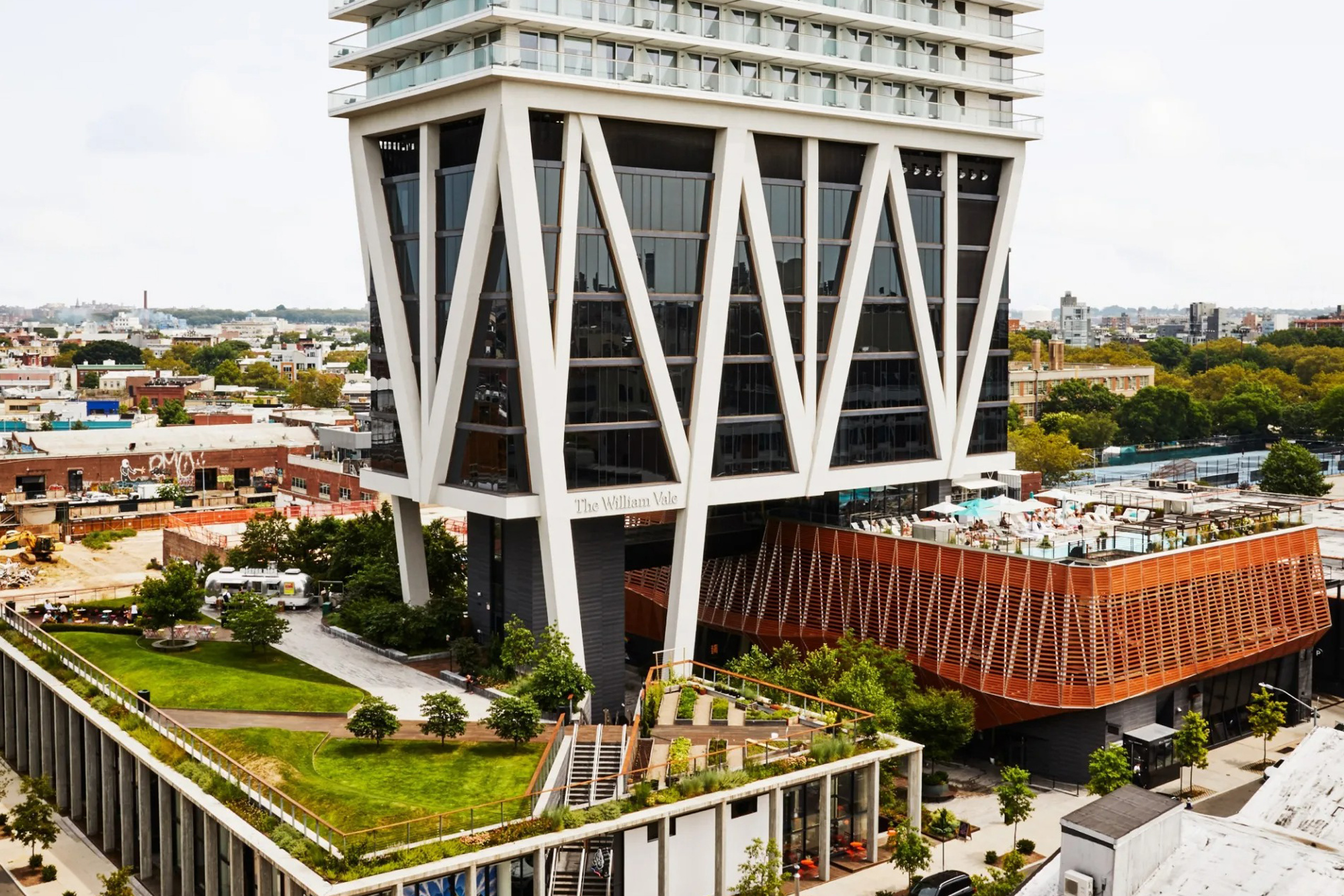 Exterior view of tall modern hotel in cityscape setting