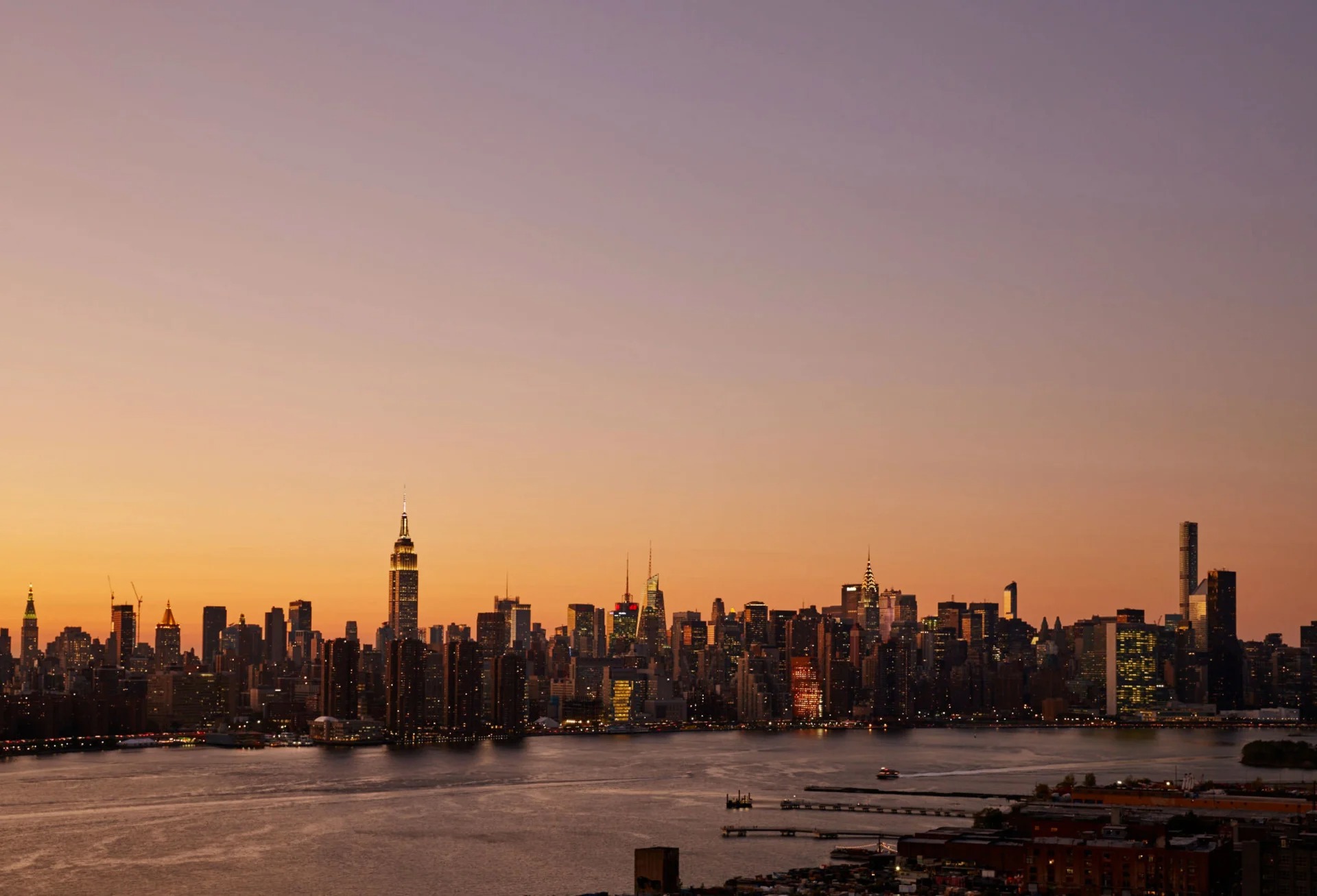 New York City skyline at sunset over the East River.