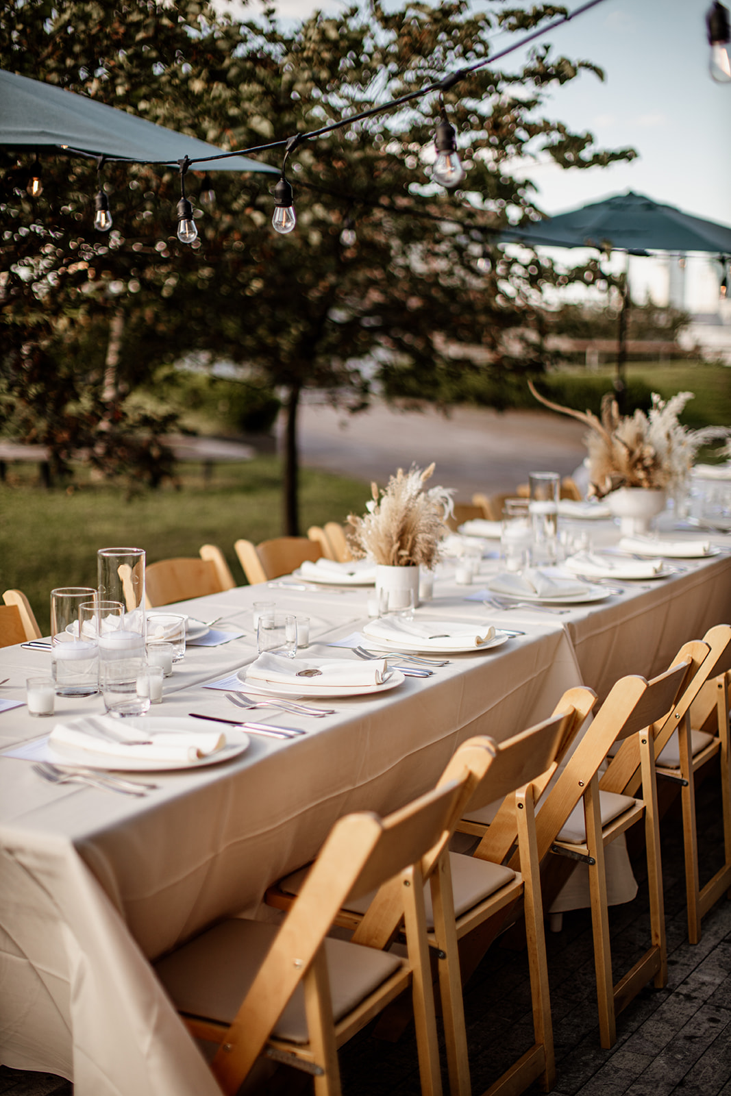 Outdoor reception table with neutral decor and candles.