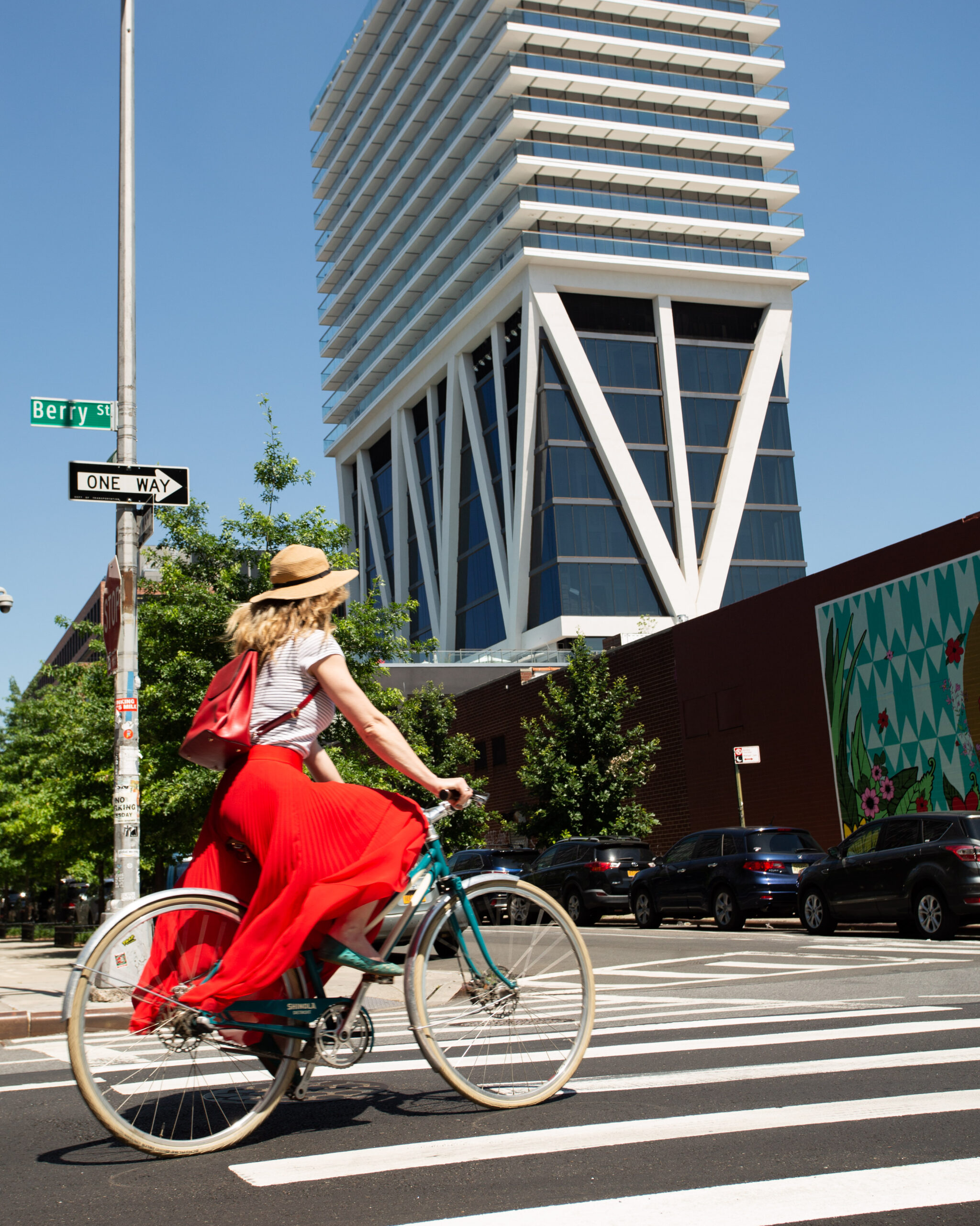 woman riding a bike in front of The William Vale hotel