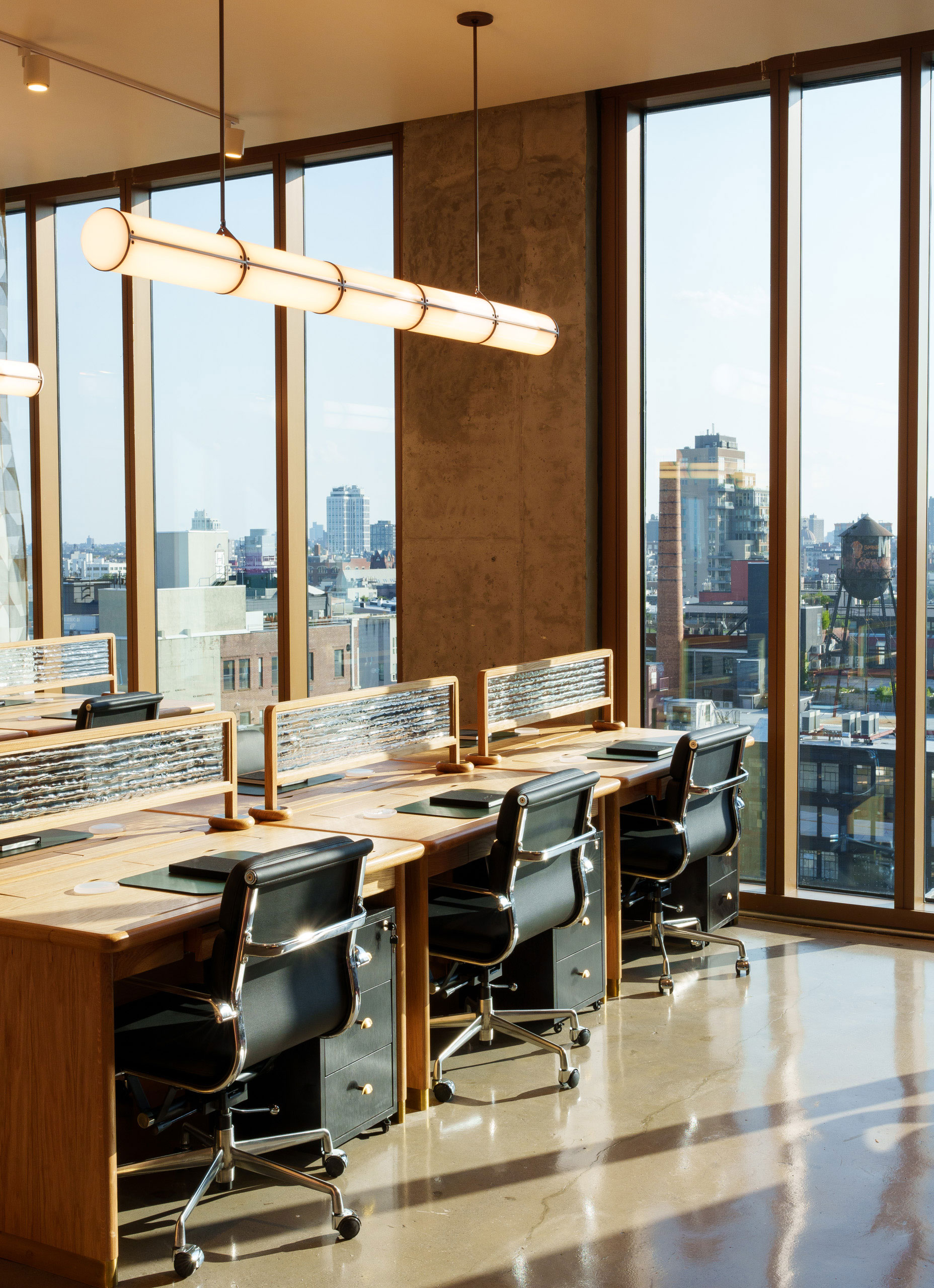modern desks and chairs in a bright, sun-filled coworking space
