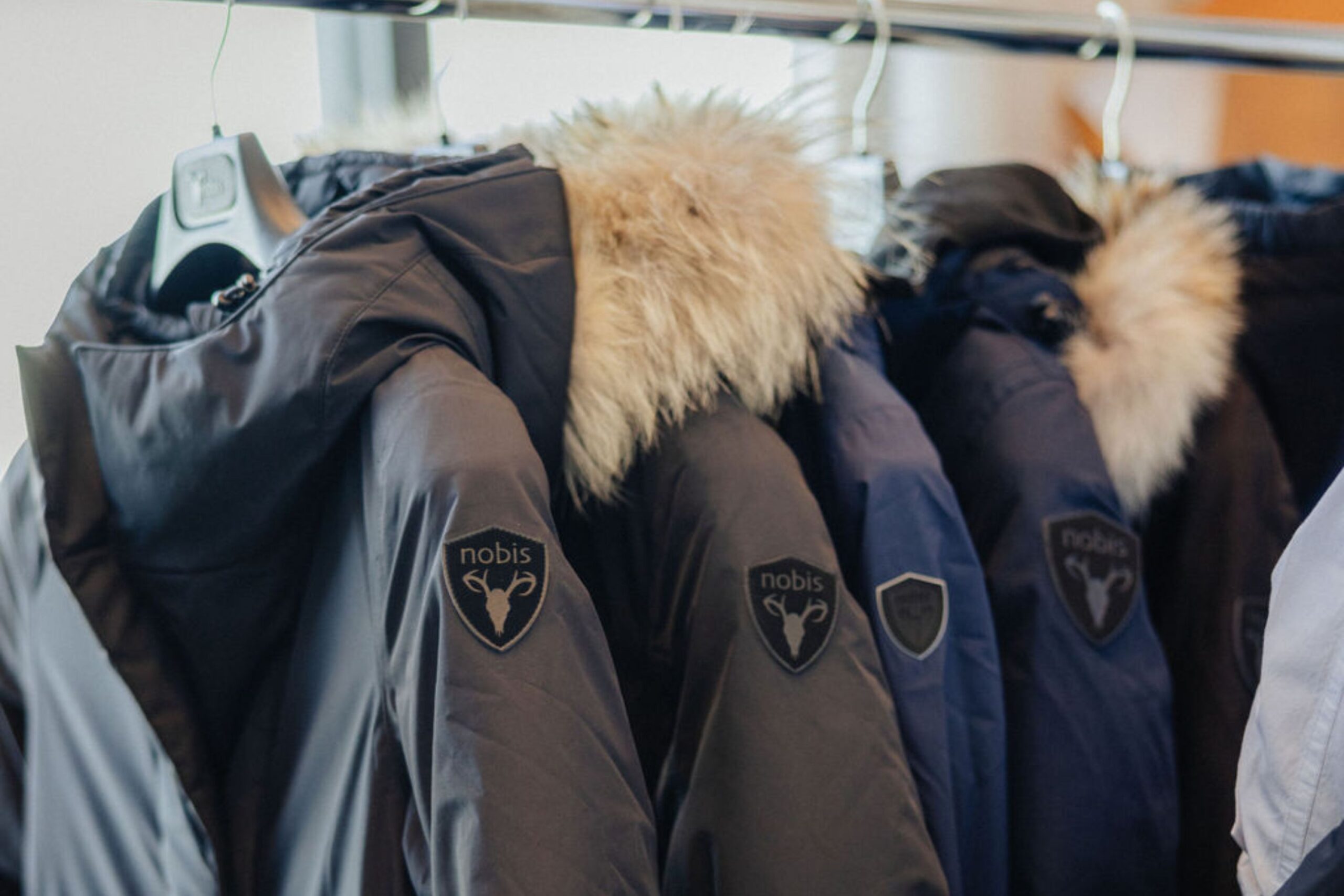 Nobis coats hang on coat rack.