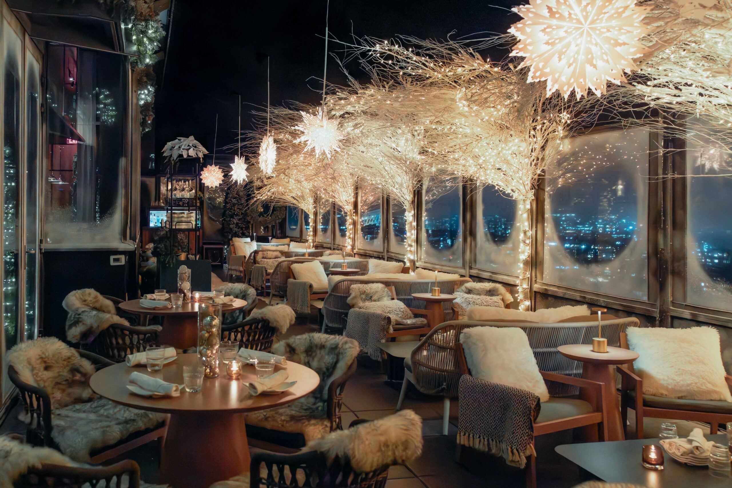 Snow Lodge at Westlight glows with illuminated trees and hanging snowflakes.