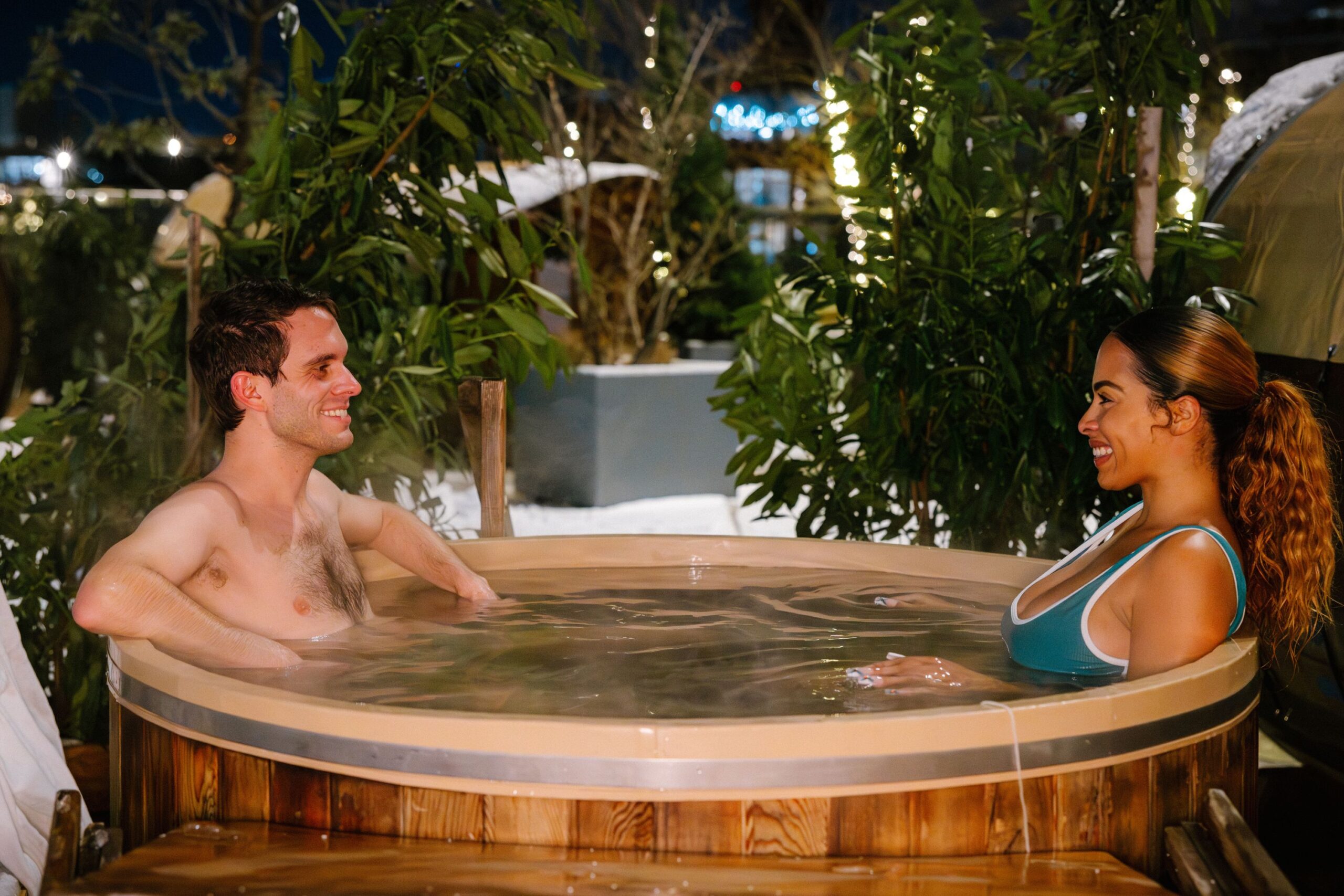 Two guests soak in deep-soaking cedar hot tub.