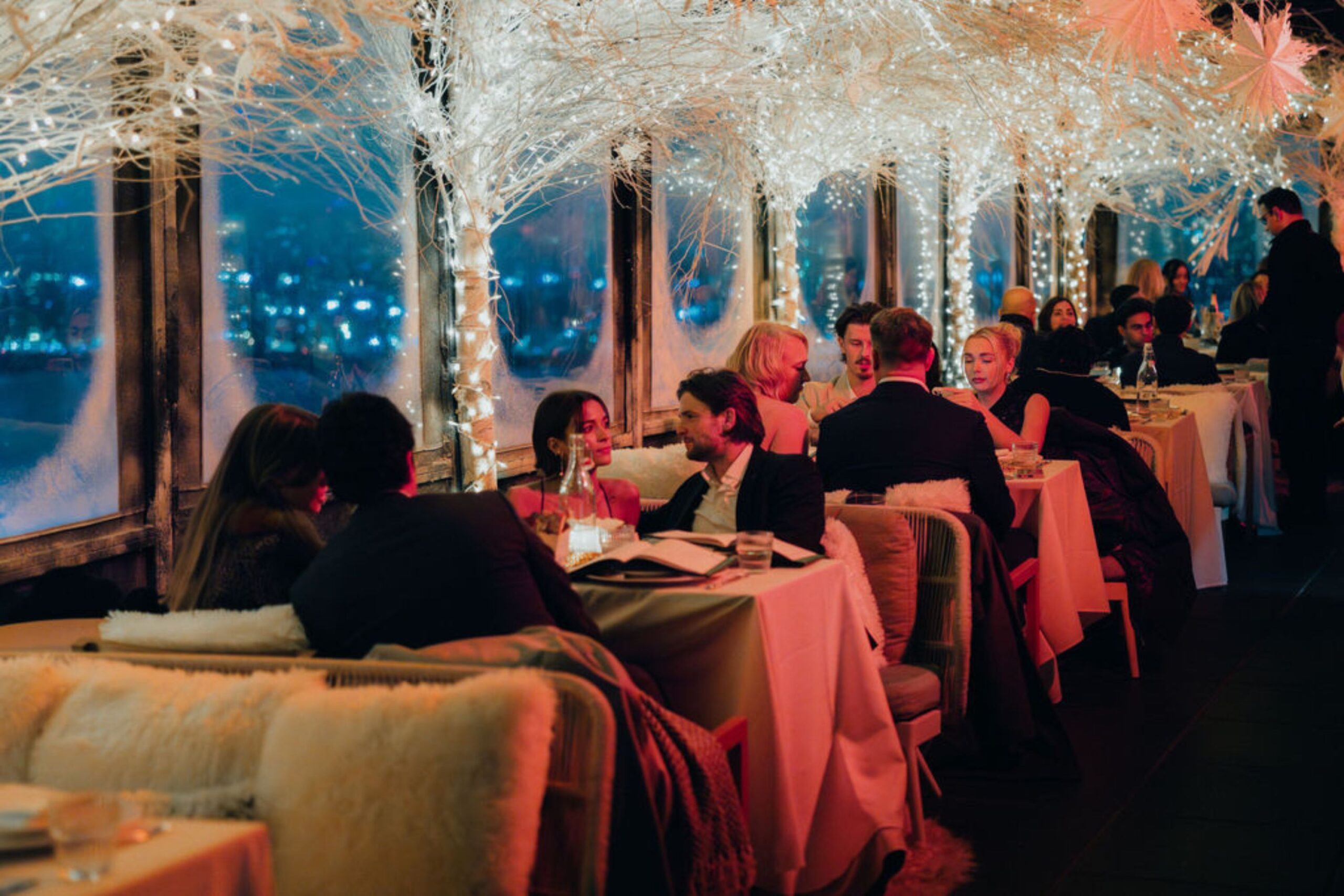 Guests sit in Snow Lodge at Westlight and enjoy a meal.