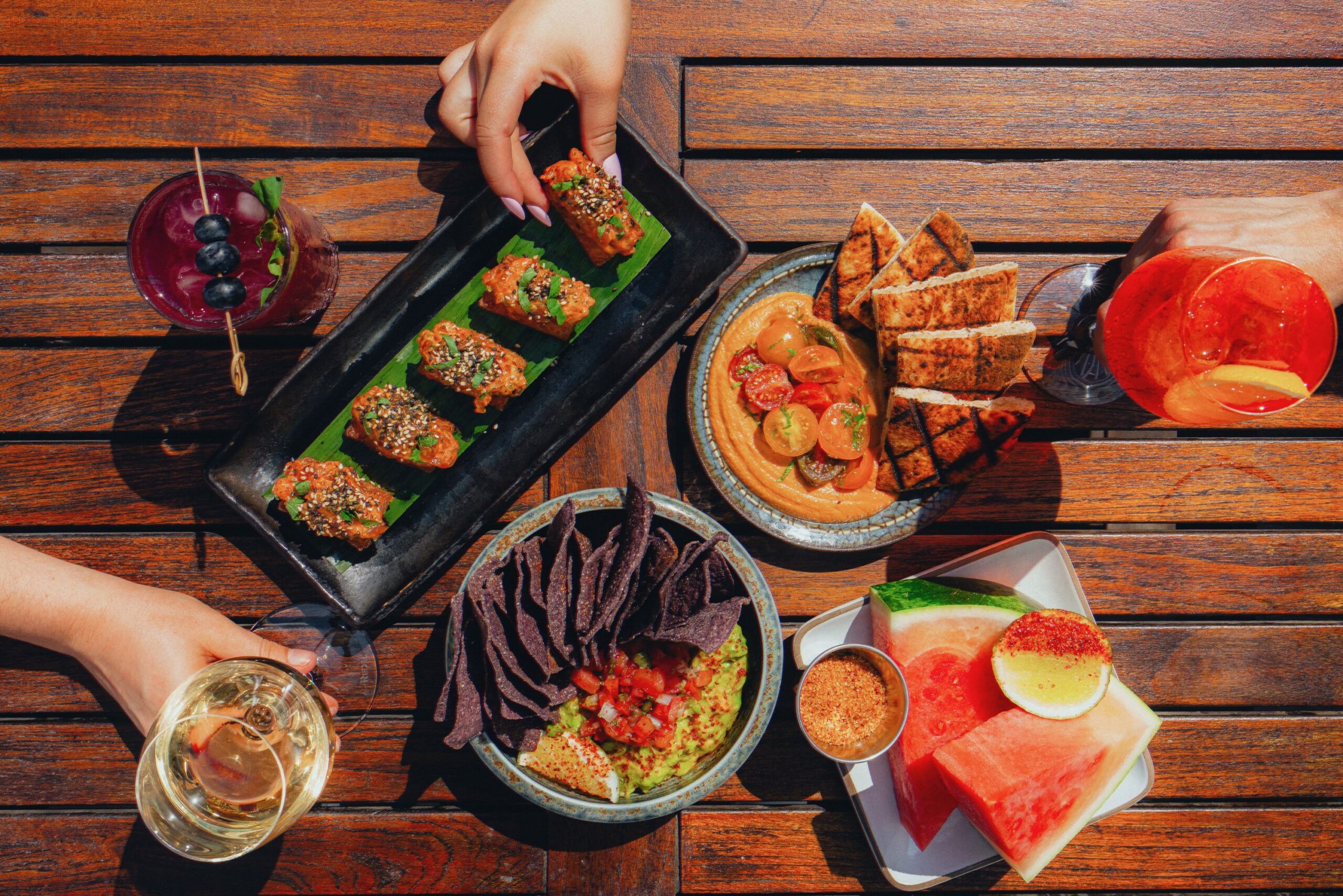 Guests enjoy a spread on a table at Vale Pool.
