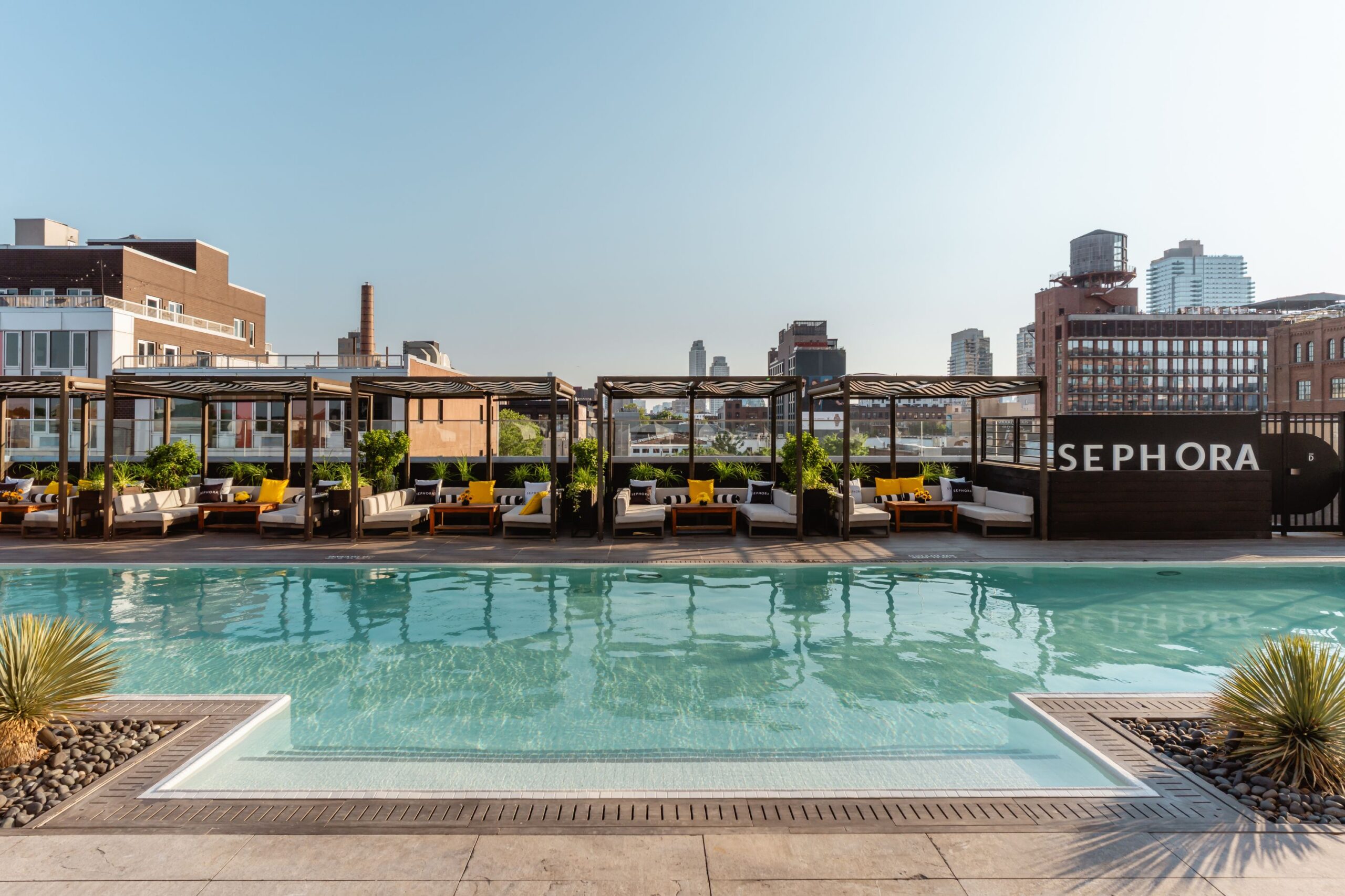 Poolside cabanas and shimmering pool at the Sephora Summer Club at The William Vale.