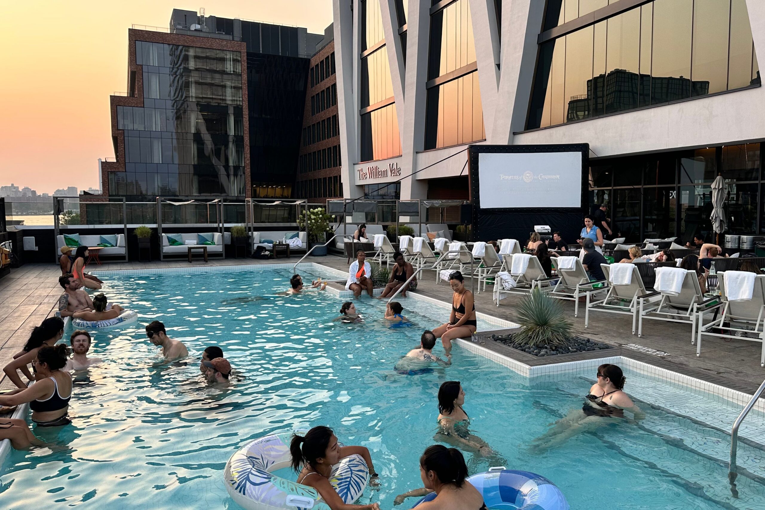 Guests lounge in Vale Pool at dive-in movie