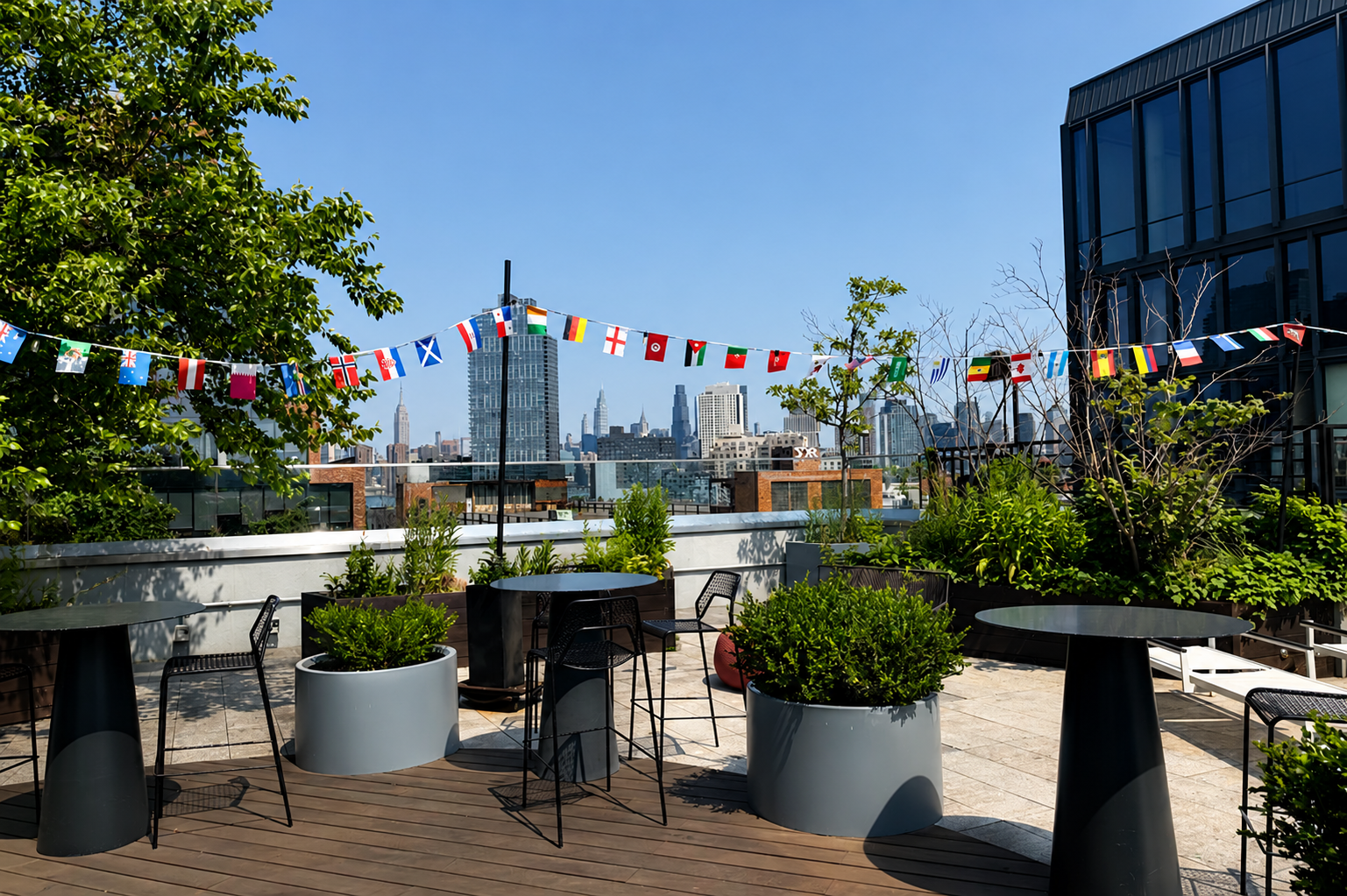 Flags hang over high top tables.