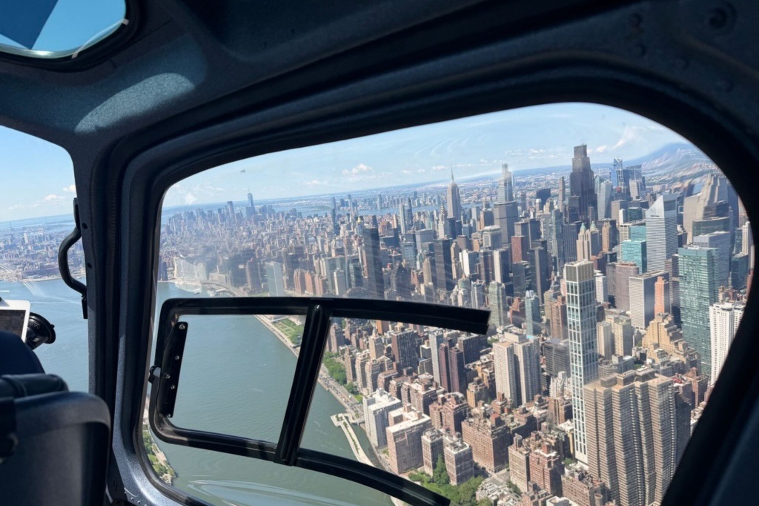 View of NYC skyline from over river in helicopter