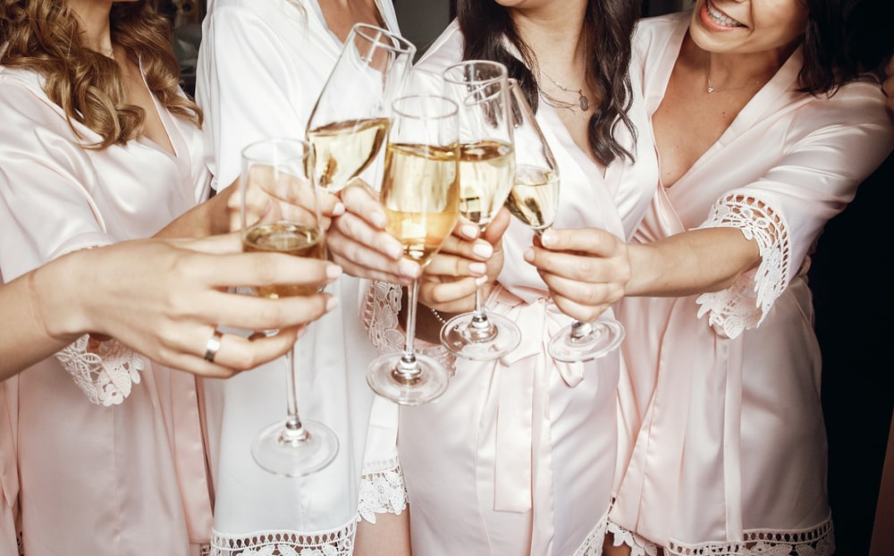 group of ladies clinking champagne glasses