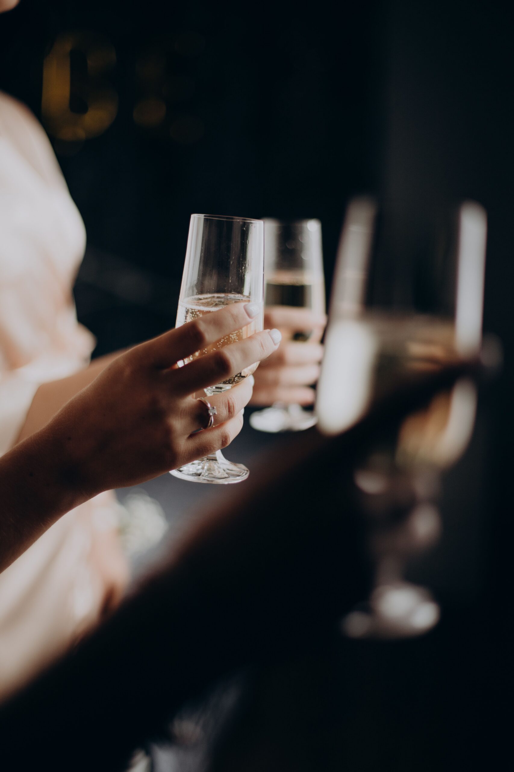 people raising a toast with champagne glasses
