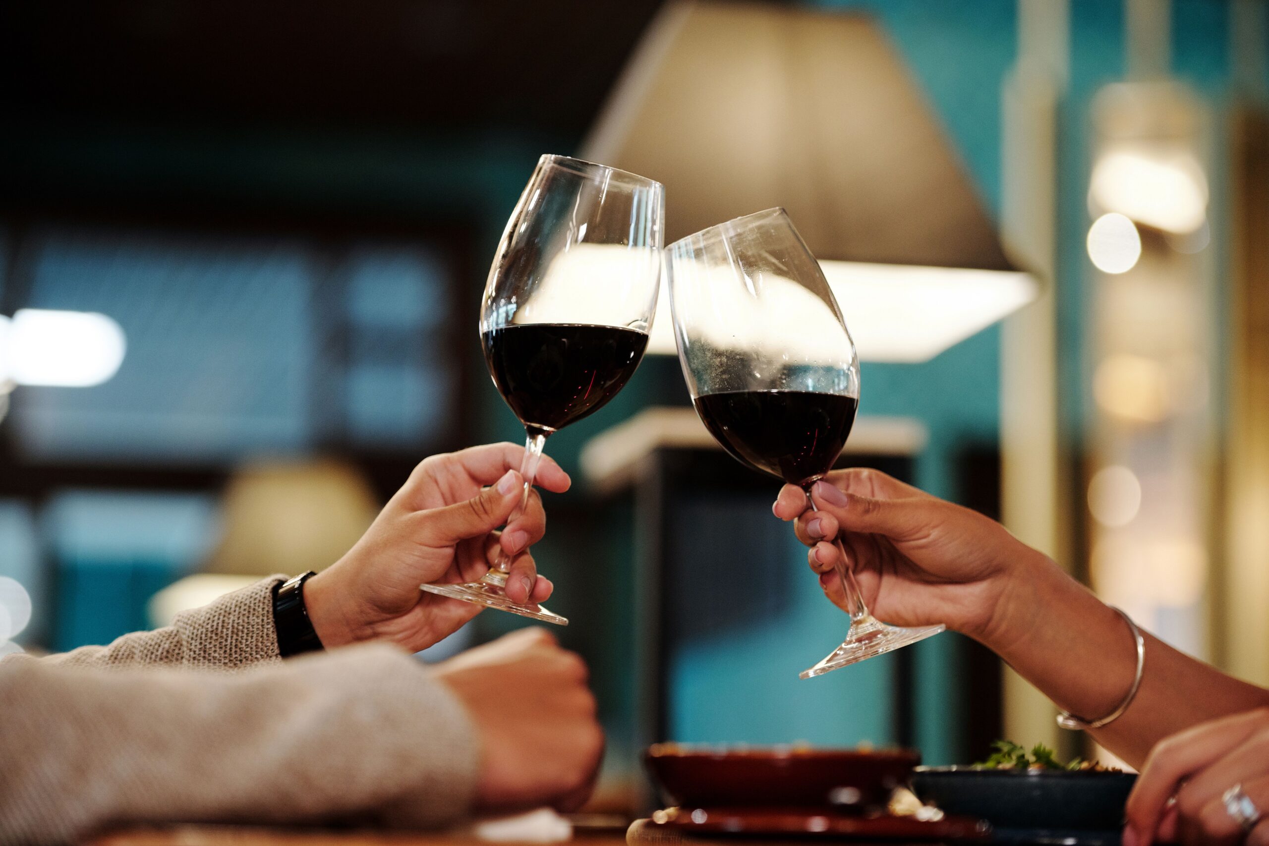 couple toasting red wine glasses